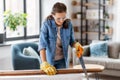 woman with saw sawing wooden board at home Royalty Free Stock Photo