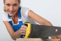 Woman sawing wood