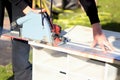 Woman sawing wood plank