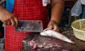 The woman Scale and clean fish for sell at market