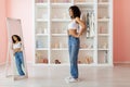 Woman on scale in jeans with a confident pose Royalty Free Stock Photo