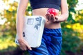 Woman with scale and red apple outdoor. Slimming, diet and healthy lifestyles concept Royalty Free Stock Photo