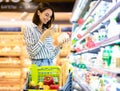 Woman scanning code on products using smartphone