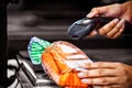 Woman scanning goods at checkout counter Royalty Free Stock Photo