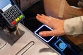 Woman scanning her palm to pay wireless, futuristic payment technology
