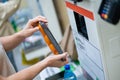 A woman scans products at a self-checkout counter. Close-up of female hands self buying groceries in the supermarket Royalty Free Stock Photo