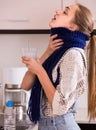 Woman in scarf gargling throat with domestic soda