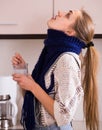Woman in scarf gargling throat with domestic soda Royalty Free Stock Photo