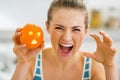 Woman scaring with orange with hallowing face Royalty Free Stock Photo