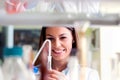 Woman scientist carrying out experiment in research laboratory