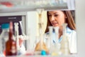 Woman scientist carrying out experiment in research laboratory