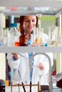 Woman scientist carrying out experiment in research laboratory
