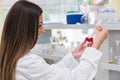 Woman scientist carrying out experiment in research laboratory