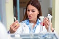 Woman scientist carrying out experiment in research laboratory