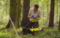 Scientist ecologist in the forest taking samples of moss Royalty Free Stock Photo