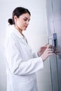 Woman Scientist in Facility Typing on Control Panel Royalty Free Stock Photo