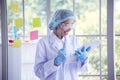 Woman scientist hand write note information in medical lab look at science microscope medical test, research biology chemistry. Royalty Free Stock Photo