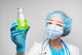 Woman scientist holding laboratory flask with chemical liquid, gray background Royalty Free Stock Photo