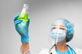 Woman scientist holding laboratory flask with chemical liquid, gray background Royalty Free Stock Photo