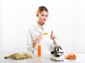 Woman scientist injecting vegetables with synthetic substances, color, vitamin