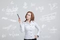 Woman scientist or student with pen working with various high school maths and science formula. Royalty Free Stock Photo
