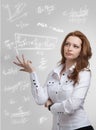 Woman scientist or student working with various high school maths and science formula. Royalty Free Stock Photo