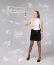 Woman scientist or student working with various high school maths and science formula. Royalty Free Stock Photo