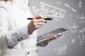 Woman scientist or student working with various high school maths and science formula. Royalty Free Stock Photo