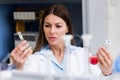 Woman scientist carrying out experiment in research laboratory