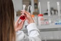 Woman scientist carrying out experiment in research laboratory