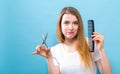 Woman with scissors and comb in salon hair cutting theme Royalty Free Stock Photo