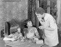 Woman scolding her two daughters for playing with matchsticks Royalty Free Stock Photo