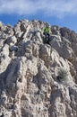 Woman Scrambling Down Cliff Royalty Free Stock Photo