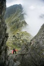 Woman scrambling in the mountains Royalty Free Stock Photo