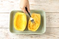 Woman scraping flesh of cooked spaghetti squash Royalty Free Stock Photo