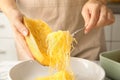 Woman scraping flesh of cooked spaghetti squash Royalty Free Stock Photo