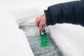 Woman scraping ice and snow