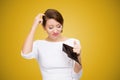 Woman scratching in head and looking inside of empty wallet having no money Royalty Free Stock Photo