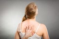 Woman scratching her itchy back with allergy rash Royalty Free Stock Photo