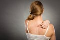 Woman scratching her itchy back with allergy rash