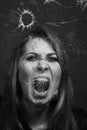 Woman screaming through broken glass. Black and white