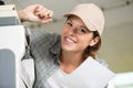 woman with screwdriver servicing professional printer