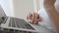 Woman scrolling a page with trackpad on laptop