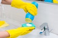 Woman scrubbing the handbasin in the bathroom Royalty Free Stock Photo