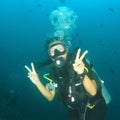 Woman diver swimming in deep blue water Royalty Free Stock Photo