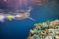 Woman scuba diver pointing to corals