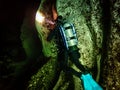 A woman scuba diver shines a dive light into the spring vent at Blue Springs State Park, Volusia County, Florida Royalty Free Stock Photo