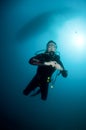 Woman scuba diver swimming in clear blue water Royalty Free Stock Photo