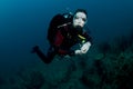 Woman scuba diver swimming in clear blue water Royalty Free Stock Photo