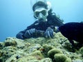 Woman Scuba diving at sea coral reef okinawa taking photography aquatic underwater